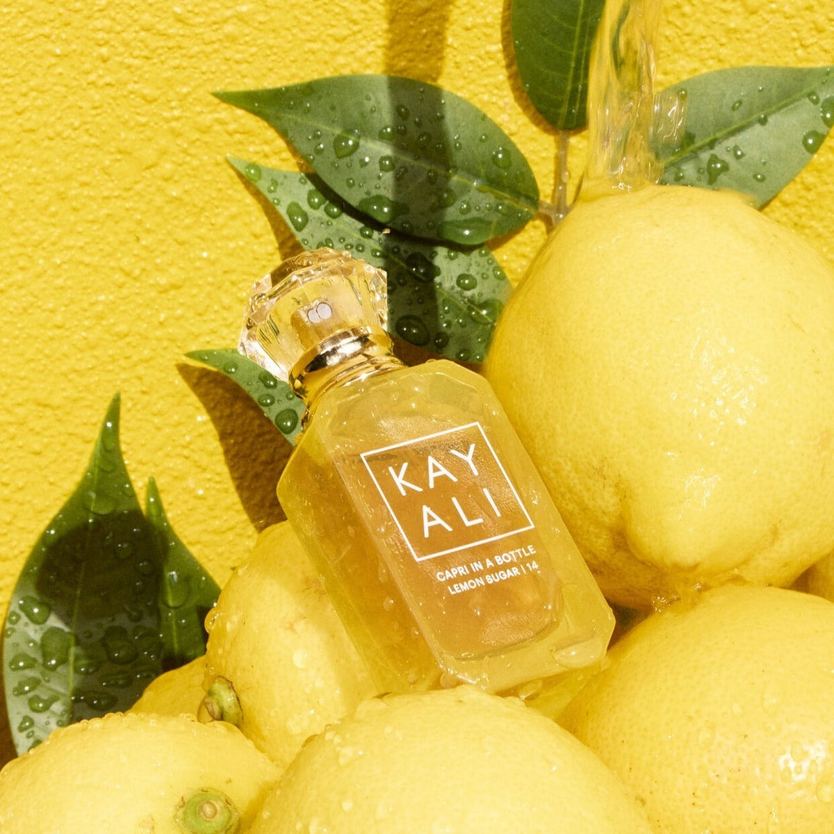 Kayali Capri in a Bottle Lemon Sugar 14 Eau de Parfum 100ml bottle featuring a sleek design and bright lemon scent.