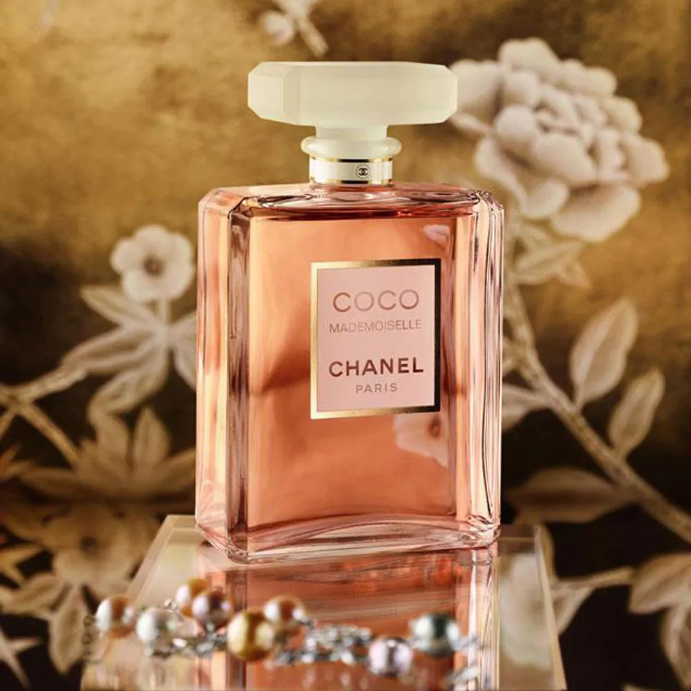 Chanel Coco Mademoiselle 100ML perfume bottle with elegant design and pink accents, showcasing a luxurious fragrance.