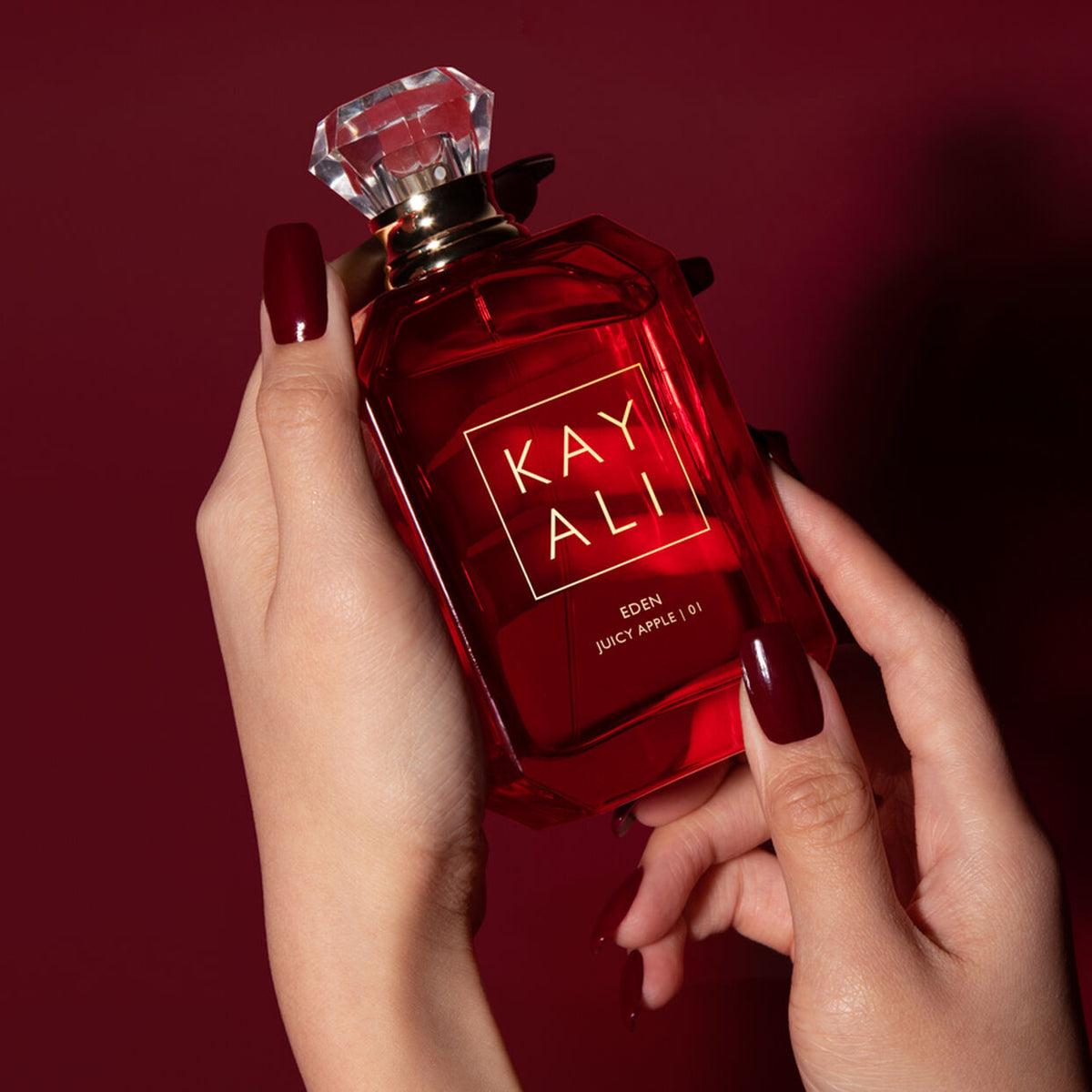 Kayali Eden Juicy Apple 100ml Eau de Parfum bottle with apple and floral design on the packaging.