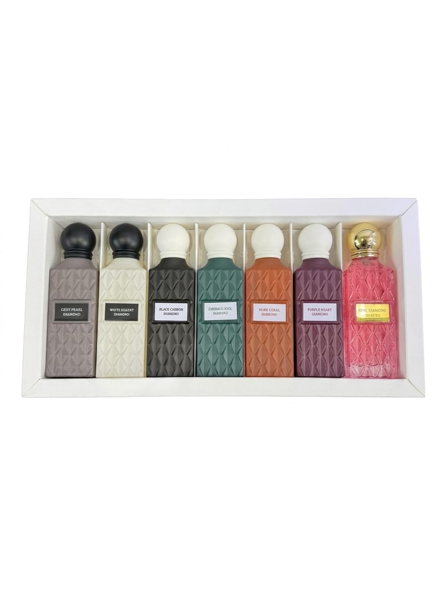 Diamond Collection by Ibrahim Al Qurashi, 7x75ml perfume bottles, elegant glass bottles with ornate caps, displayed on a reflective surface.