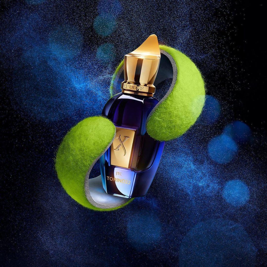 Xerjoff Torino21 perfume bottle, 100ml, with elegant black and gold design, sitting on a reflective surface.