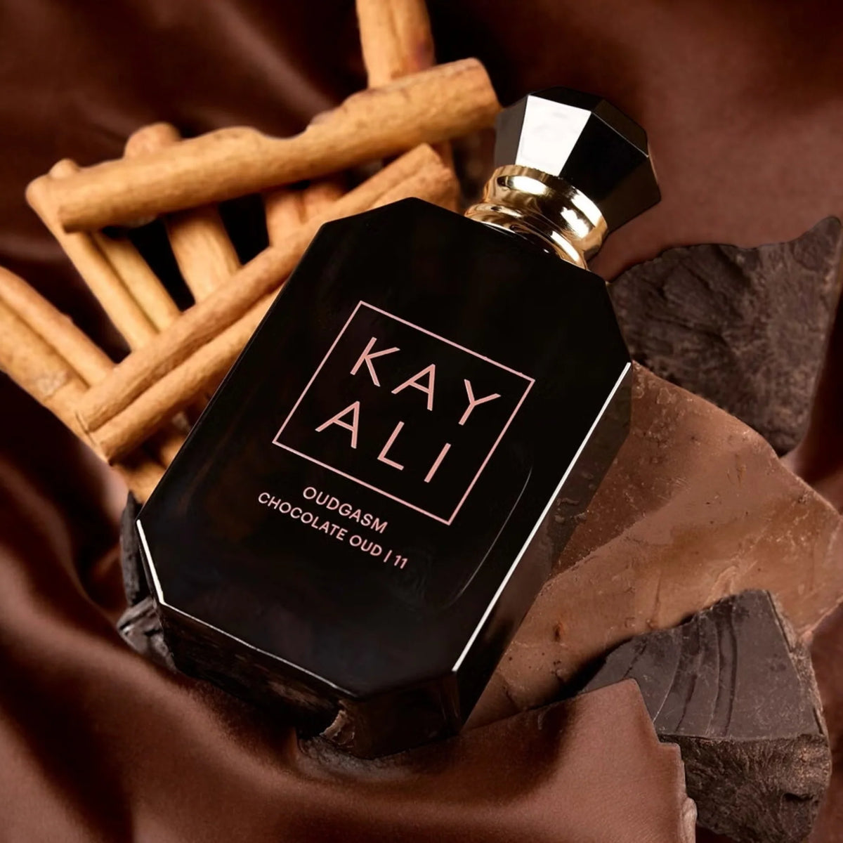Kayali Oudgasm Chocolate Oud fragrance bottle with 11 Kayali fragrances, 100ml, shown alongside a stylish lifestyle background.