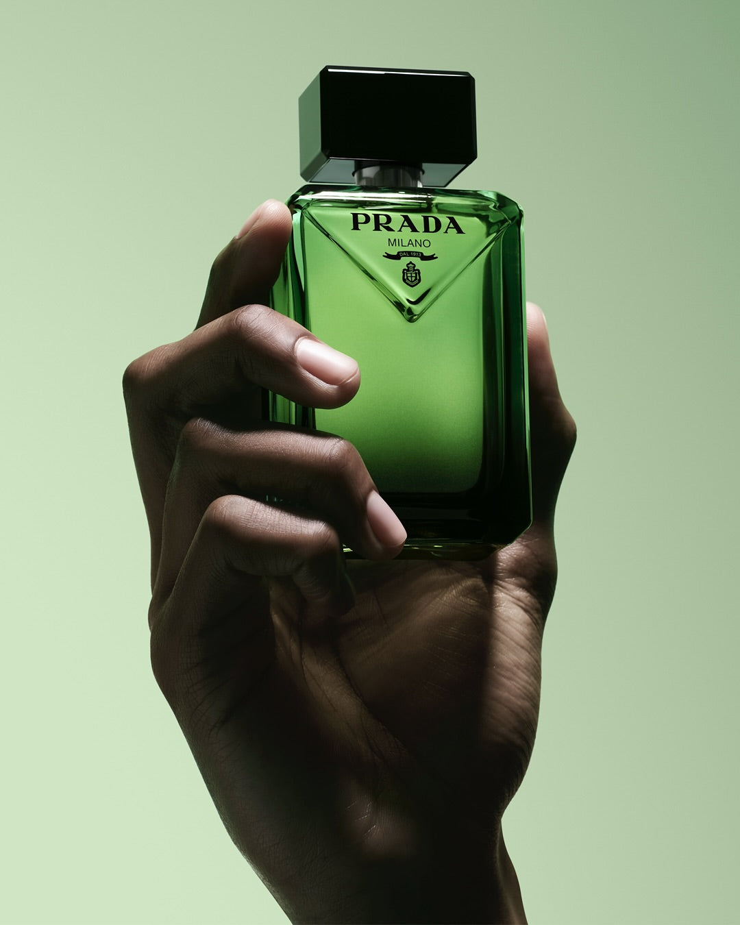 Prada Paradigme perfume bottle with sleek design, 100ml size, clear glass, and silver accents.